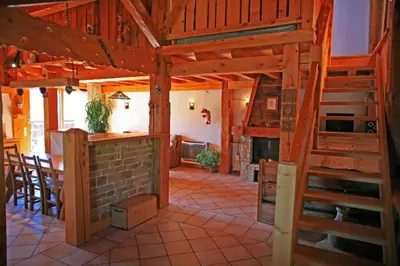 a large kitchen and living room with a wooden ceiling at Chalet L' Irrawaddy in Megève