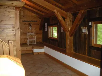 an empty room in a log cabin with windows at Chalet L' Irrawaddy in Megève