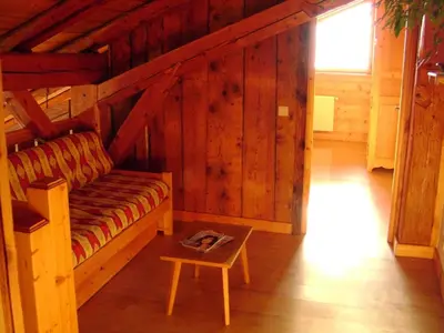 a living room with a couch and a table at Chalet L' Irrawaddy in Megève