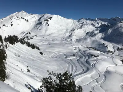 a snow covered mountain with a river in it at Apt Sakura - Le Grand Tetras in Samoëns