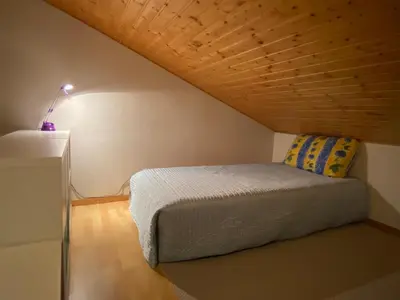 a bedroom with a bed with a wooden ceiling at Apt Sakura - Le Grand Tetras in Samoëns