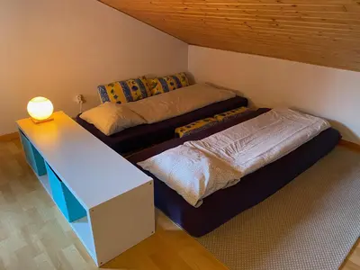a small room with two beds and a table at Apt Sakura - Le Grand Tetras in Samoëns