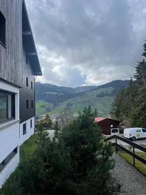 a building with a view of a valley and a house at LOUE STUDIO MEGEVE in Megève