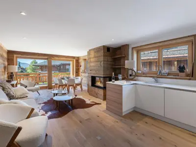 a kitchen and living room with a fireplace at Appartement lumineux de 100 m² avec balcon, proche centre Megève, 4 adultes et 2 enfants - FR-1-569-87 in Megève