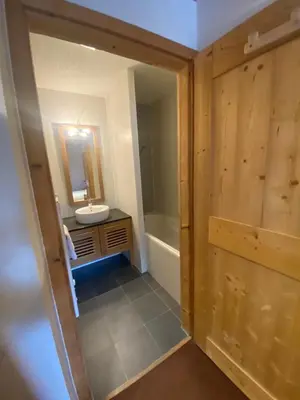 a bathroom with a sink and a tub and a mirror at French Alps Luxury in Vallorcine