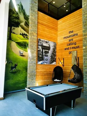 a ping pong table in a room with a wall at French Alps Luxury in Vallorcine
