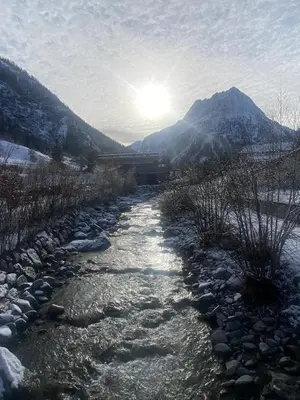 a river with snow on the sides of a mountain at French Alps Luxury in Vallorcine