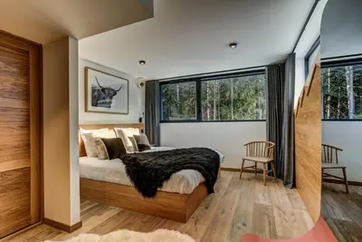a bedroom with a bed and a large window at Black Pearl in Chamonix-Mont-Blanc