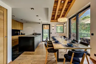 a kitchen and dining room with a long table and chairs at Black Pearl in Chamonix-Mont-Blanc