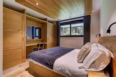 a bedroom with a large bed and a window at Black Pearl in Chamonix-Mont-Blanc