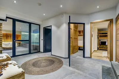 a living room with glass doors and a rug at Black Pearl in Chamonix-Mont-Blanc
