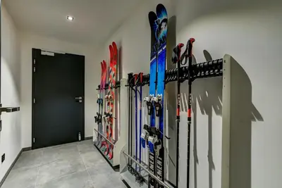 a bunch of skis are lined up against a wall at Black Pearl in Chamonix-Mont-Blanc