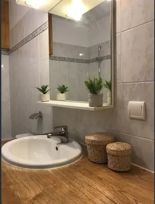 a bathroom with a sink and a mirror at Duplex Sallanches - Terrasse, Centre & Parking by AlpenlySallanches in Sallanches