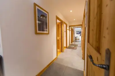 a hallway of a house with a picture on the wall at Grand Paradis B01 - Modern with great location in Chamonix-Mont-Blanc