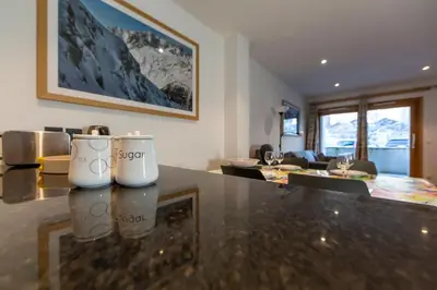 a kitchen and living room with a counter top at Grand Paradis B01 - Modern with great location in Chamonix-Mont-Blanc