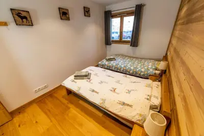 a small room with a bed and a couch at Grand Paradis B01 - Modern with great location in Chamonix-Mont-Blanc