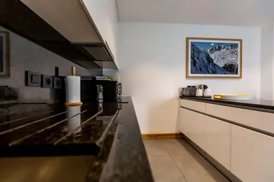 a kitchen with a stove top oven in a room at Grand Paradis B01 - Modern with great location in Chamonix-Mont-Blanc