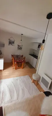 a living room with a table and a couch at Appartement vue montagne proximité ski et parcours TMB in Les Contamines-Montjoie