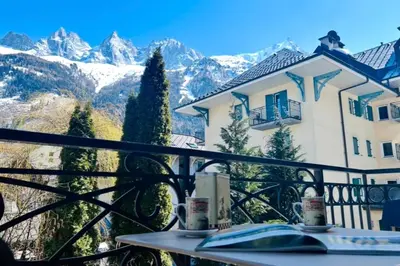 a large white building on the side of a street at Cosy cocoon in the heart of Chamonix in Chamonix-Mont-Blanc