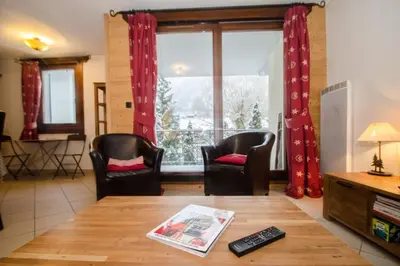 a living room with a table and a dining room at Cosy cocoon in the heart of Chamonix in Chamonix-Mont-Blanc