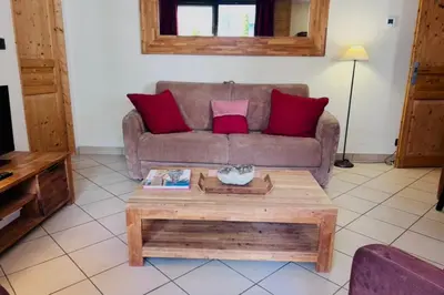 a bedroom with a large white bed with a window at Cosy cocoon in the heart of Chamonix in Chamonix-Mont-Blanc