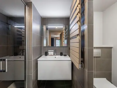 a bathroom with a sink and a mirror at Bel appartement à Megève dans résidence avec piscine - FR-1-569-105 in Megève