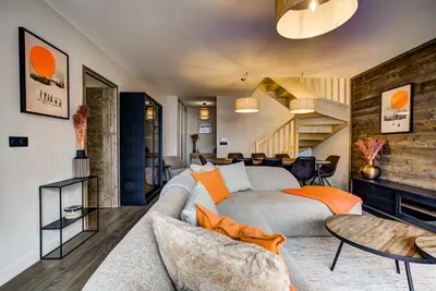 a living room with a couch and a table at White Pearl Apartments in Chamonix-Mont-Blanc
