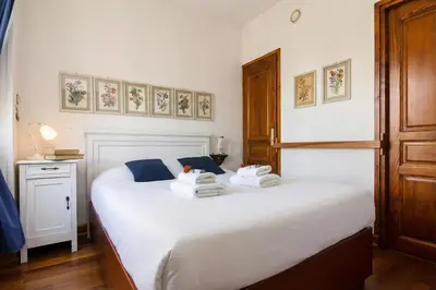 a bedroom with a white bed with towels on it at Appartement Belle Epoque - Happy Rentals in Chamonix-Mont-Blanc