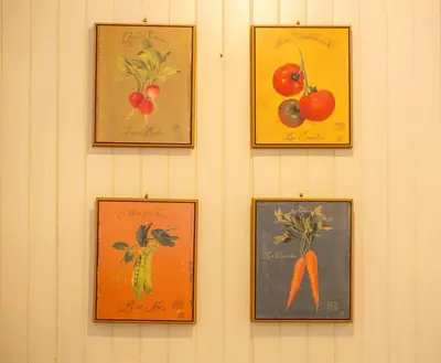 a wall with four pictures of vegetables on it at Majestic T2 calme, spacieux, central, avec parking in Chamonix-Mont-Blanc