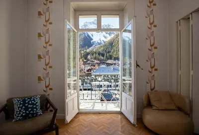 a living room with a large window with a view at Majestic T2 calme, spacieux, central, avec parking in Chamonix-Mont-Blanc