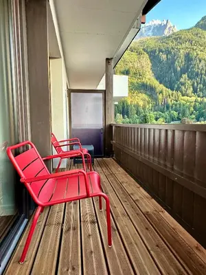 two red chairs sitting on a balcony with a view at Mont-Blanc View - Panoramic Balcony - Chamonix Centre in Chamonix-Mont-Blanc