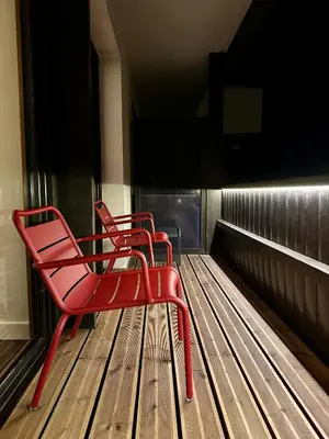 three red chairs sitting on a baseball field at Mont-Blanc View - Panoramic Balcony - Chamonix Centre in Chamonix-Mont-Blanc