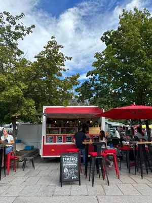 a food truck with people sitting at tables in front of it at Mont-Blanc View - Panoramic Balcony - Chamonix Centre in Chamonix-Mont-Blanc