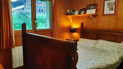 a bedroom with a bed and a window at TellaHouse in Chamonix-Mont-Blanc