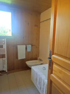 a bathroom with a tub and a toilet and a sink at TellaHouse in Chamonix-Mont-Blanc