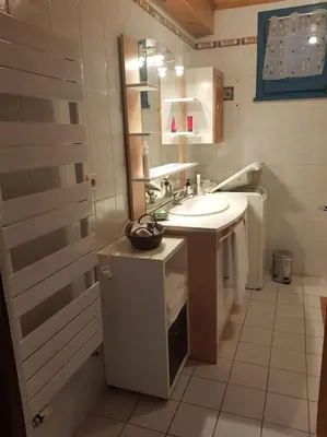 a bathroom with a sink and a toilet at Appartement belle vue in Combloux