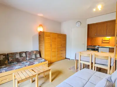 a living room with a couch and a table and a kitchen at Studio confortable, balcon sud, proche pistes, casier à ski - FR-1-425-203 in Arâches-la-Frasse