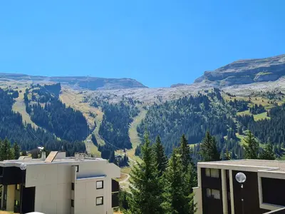 a view of the mountains from a building at Studio confortable, balcon sud, proche pistes, casier à ski - FR-1-425-203 in Arâches-la-Frasse