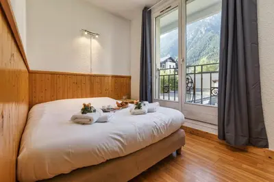 a bedroom with a bed with a bowl of fruit on it at Chamonix Sud - Bâtiment C 121 - Happy Rentals in Chamonix-Mont-Blanc