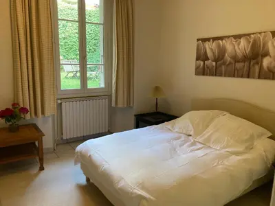 a bedroom with a white bed and a window at Le Mont Joly & Les 4 Têtes in Sallanches