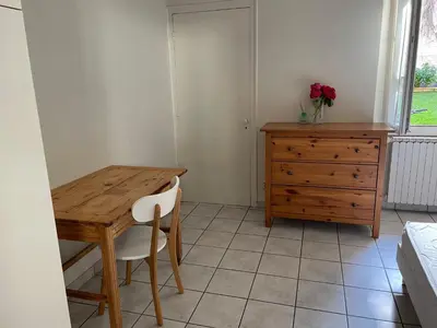 a dining room with a wooden table and a dresser at Le Mont Joly & Les 4 Têtes in Sallanches