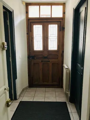 a wooden door in a room with a tile floor at Le Mont Joly & Les 4 Têtes in Sallanches