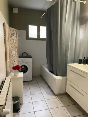 a bathroom with a shower and a washing machine at Le Mont Joly & Les 4 Têtes in Sallanches