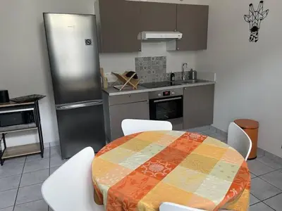 a kitchen with a table and chairs and a kitchen with a counter at Le Mont Joly & Les 4 Têtes in Sallanches