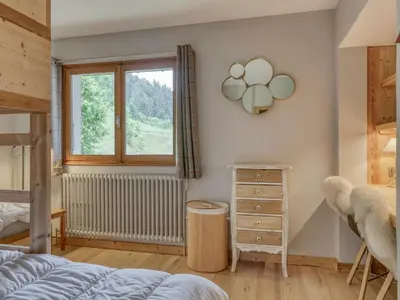 a bedroom with a bed and a window and a dresser at Appartement 3 pièces à Megève, balcon sud-est, TV et garage ski - FR-1-453-308 in Megève