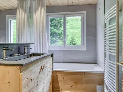 a bathroom with a tub and a sink and a window at Appartement 3 pièces à Megève, balcon sud-est, TV et garage ski - FR-1-453-308 in Megève