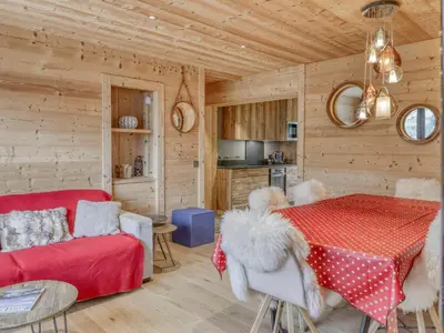a kitchen and living room with a table and a couch at Appartement 3 pièces à Megève, balcon sud-est, TV et garage ski - FR-1-453-308 in Megève