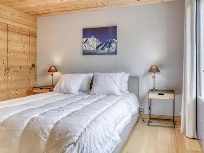 a bedroom with a large bed with white sheets at Appartement 3 pièces à Megève, balcon sud-est, TV et garage ski - FR-1-453-308 in Megève