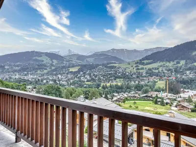 a view of a town from a balcony with mountains at Appartement 3 pièces à Megève, balcon sud-est, TV et garage ski - FR-1-453-308 in Megève
