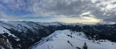 a view of a snow covered mountain range with clouds at Chalet*** au pied d'une prairie face à la montagne in Sixt